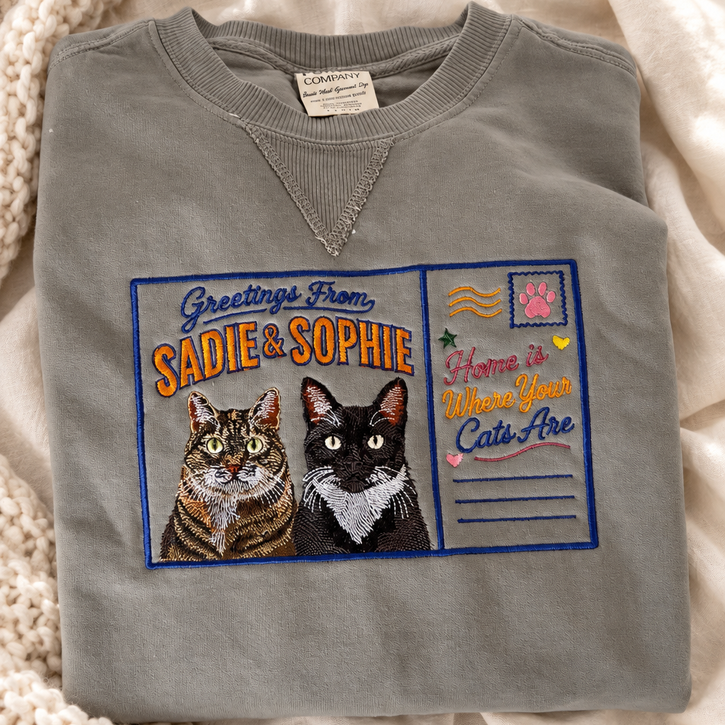 Custom embroidered two-pet sweatshirt in Pepper with a Greetings From Sadie and Sophie postcard design and two cat portraits