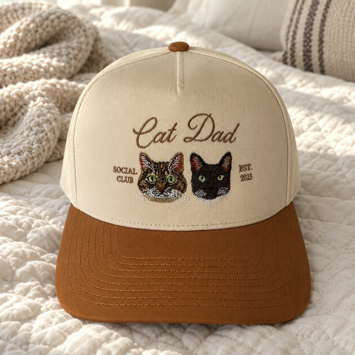 Custom embroidered pet hat with two cat portraits and Cat Dad Social Club text, cream structured snapback with brown brim